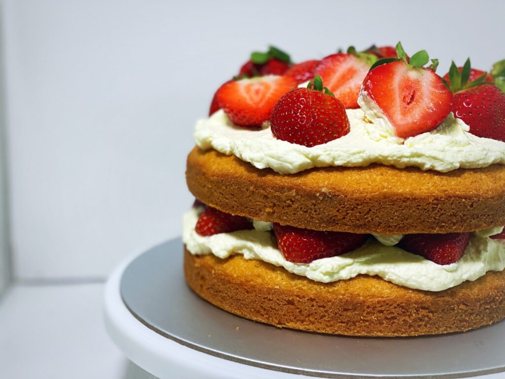 Classic Victoria Sponge Cake with cream and fresh strawberries