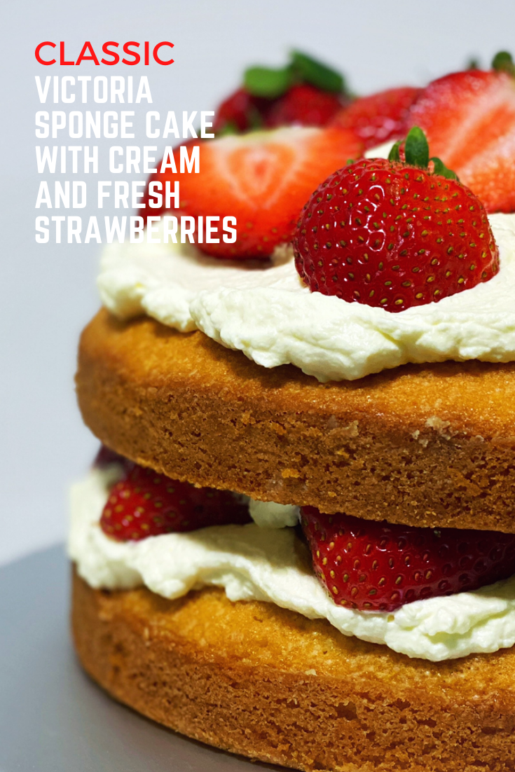 Classic Victoria Sponge Cake with cream and fresh strawberries