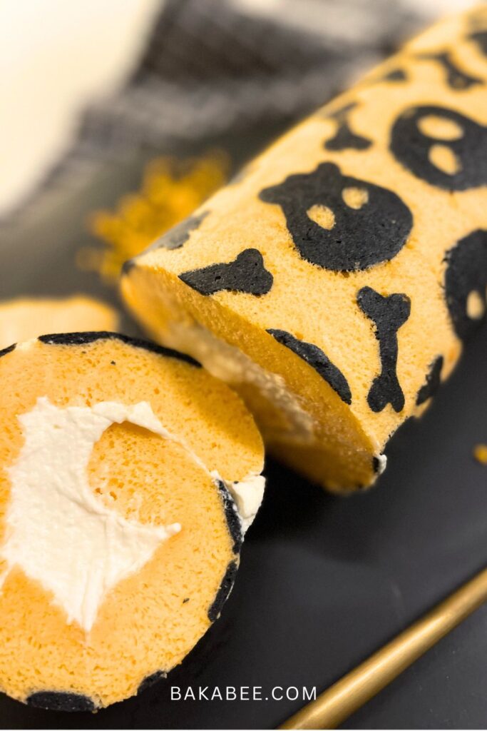 a slice of Swiss roll with whipped cream filling on a black plate