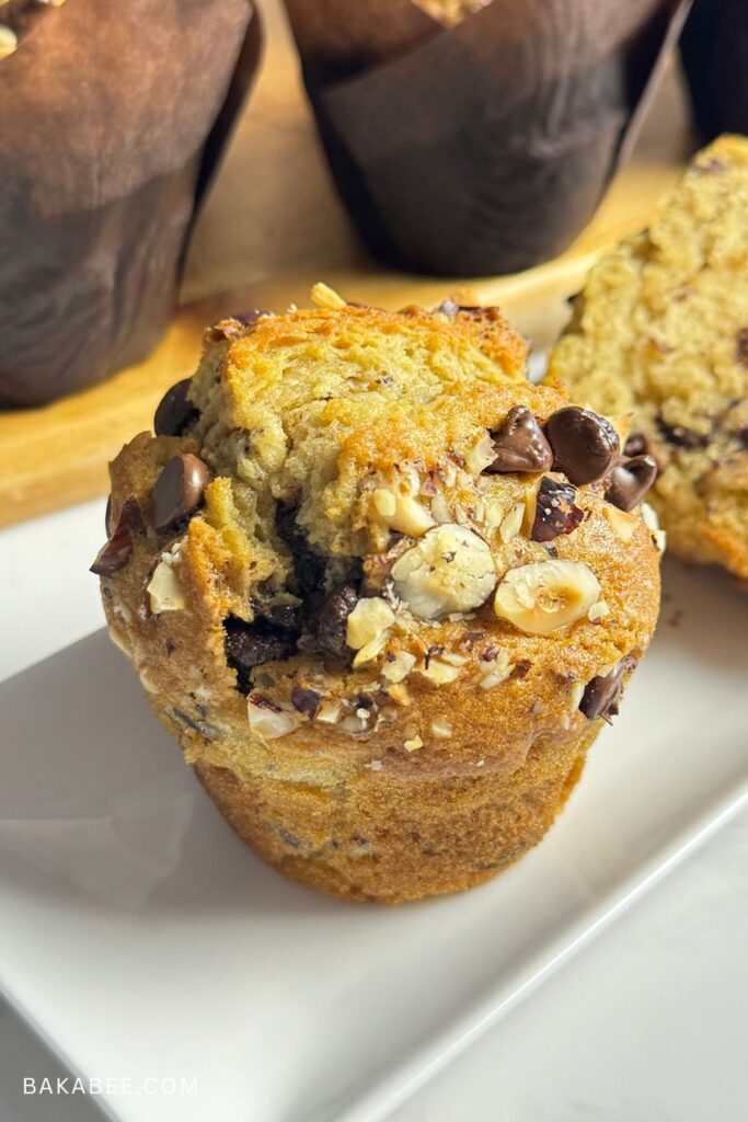 The best bakery-style chocolate chip hazelnut muffin on a serving plate