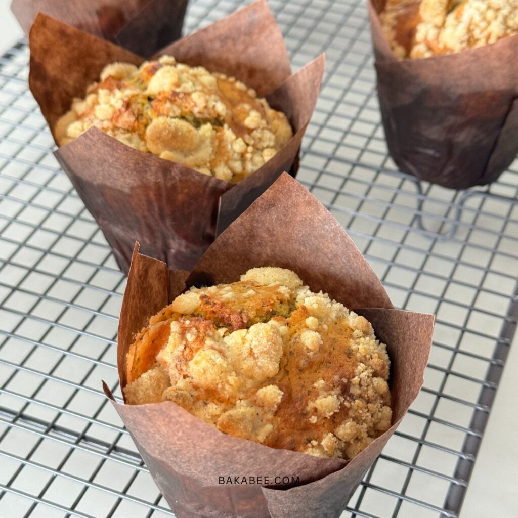 The best bakery-style lemon and poppy seed muffins cooling on a wire rack