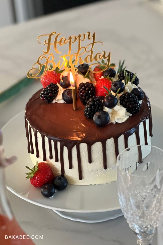 a fruit cream cake with chocolate drip for a birthday celebration