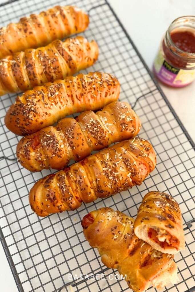 well baked cheesy sambal rolls on a wire rack