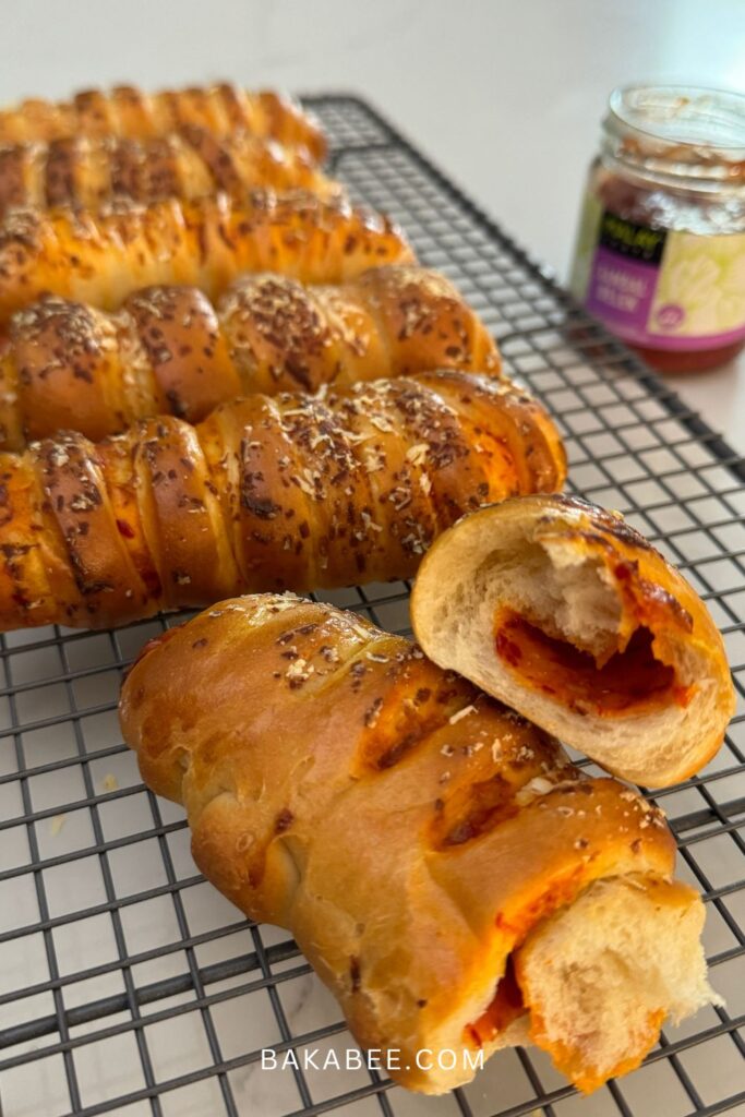 a few cheesy sambal rolls on a wire rack