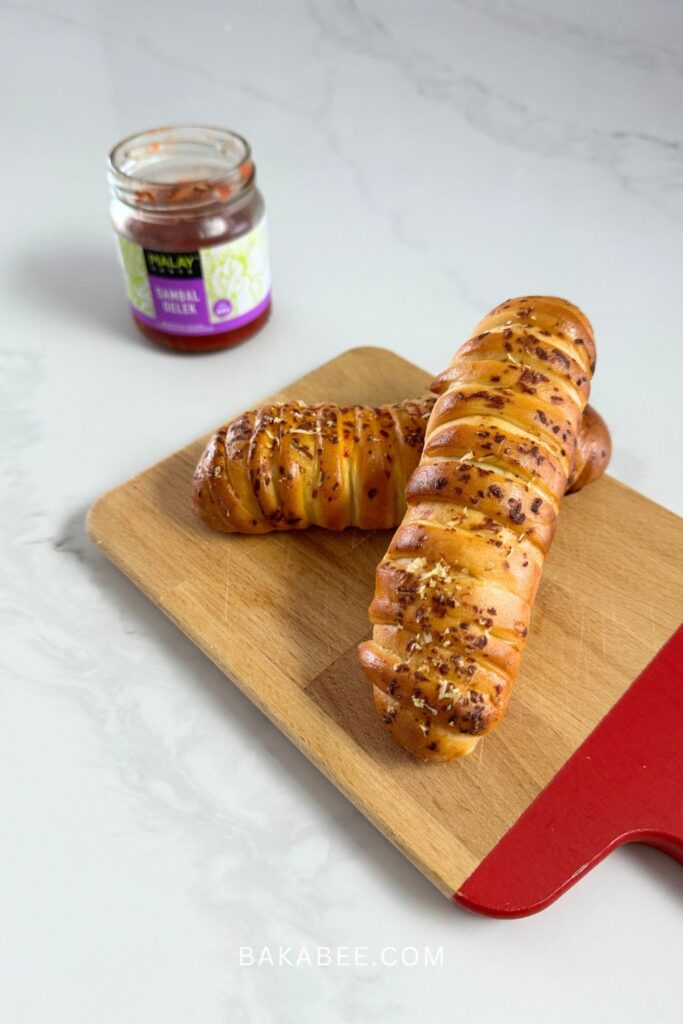 cheesy sambal rolls with a jar of sambal oelek