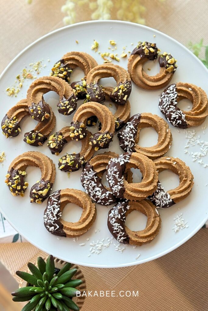 coffee Viennese whirl biscuits are served on a white plate.
