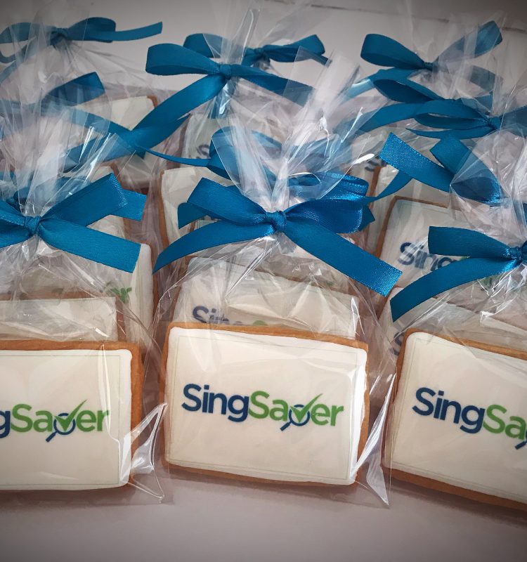 sugar cookie with edible SingSaver corporate logo