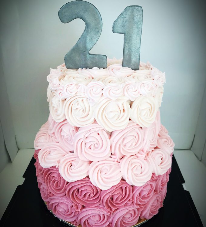 Lemon cake an chocolate cake with ombre pink buttercream decoration with a silver 21 cake topper