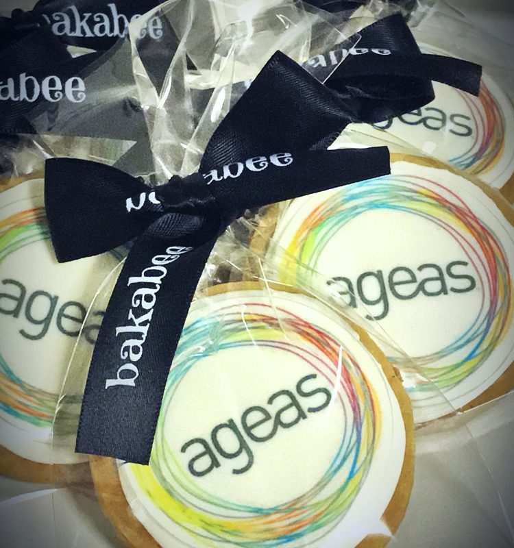 Buttery peanut sugar cookies with ageas corporate edible logos, packed in individual bags with bakabee ribbons